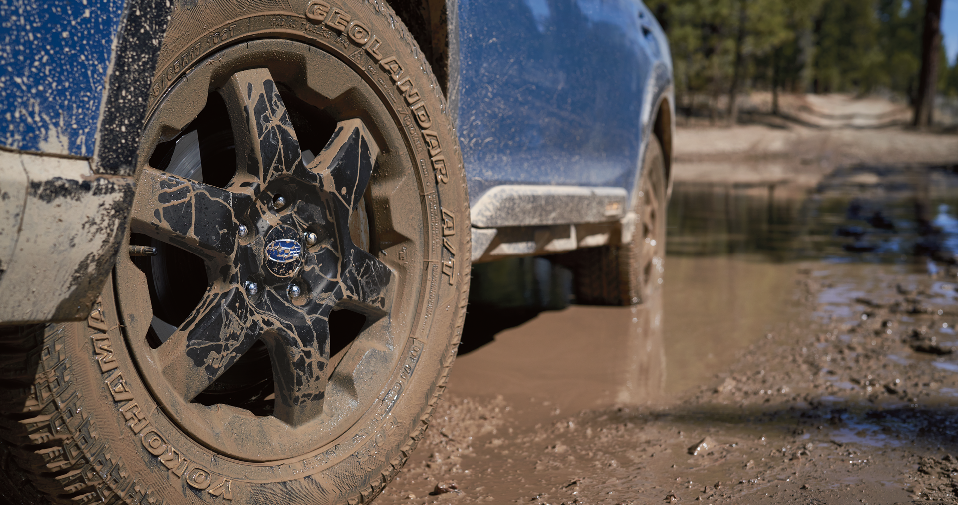 A close-up of the 17-inch off-road wheels and all-terrain Yokohama GEOLANDAR® tires on the 2023 Outback Wilderness. | Subaru of Grand Blanc in Grand Blanc MI