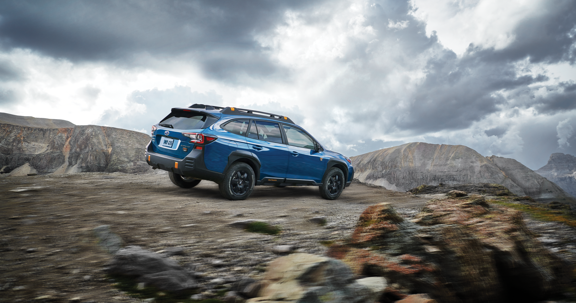 A 2023 Outback Wilderness driving on a trail in the mountains. | Subaru of Grand Blanc in Grand Blanc MI
