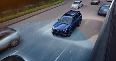 A Subaru SUV project lines on the road, representing EyeSight Driver Assist Technology.